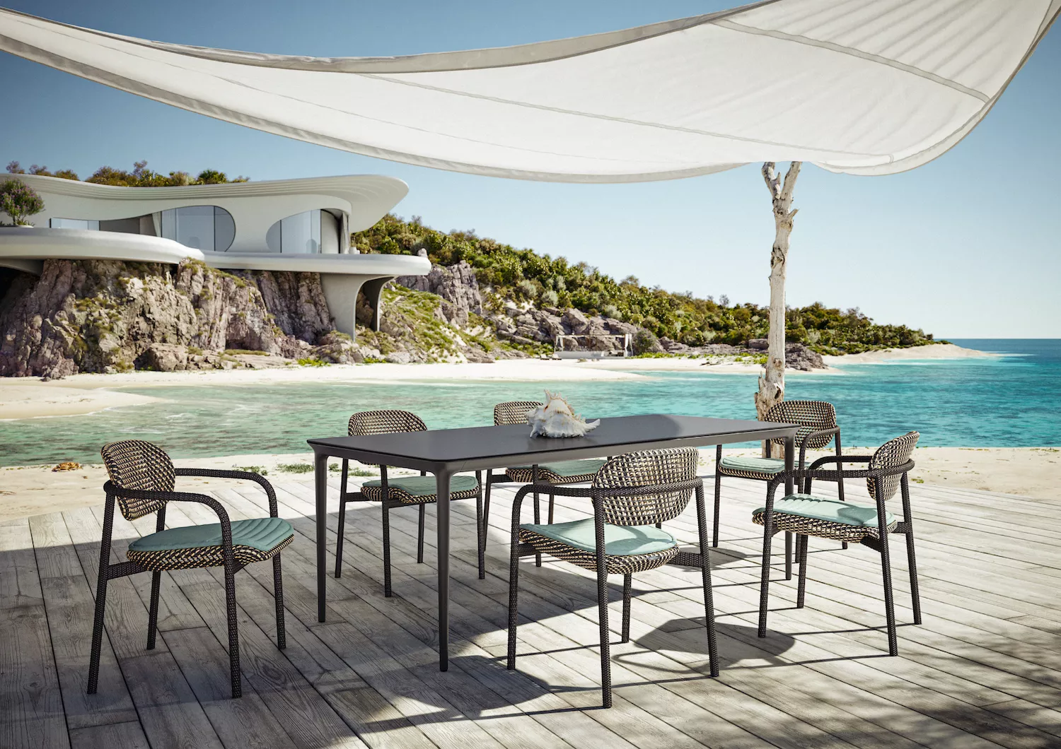 Dedon Bellmonde Essgruppe auf einer Terrasse am Meer mit modernem Haus im Hintergrund und Sonnensegel über dem Tisch