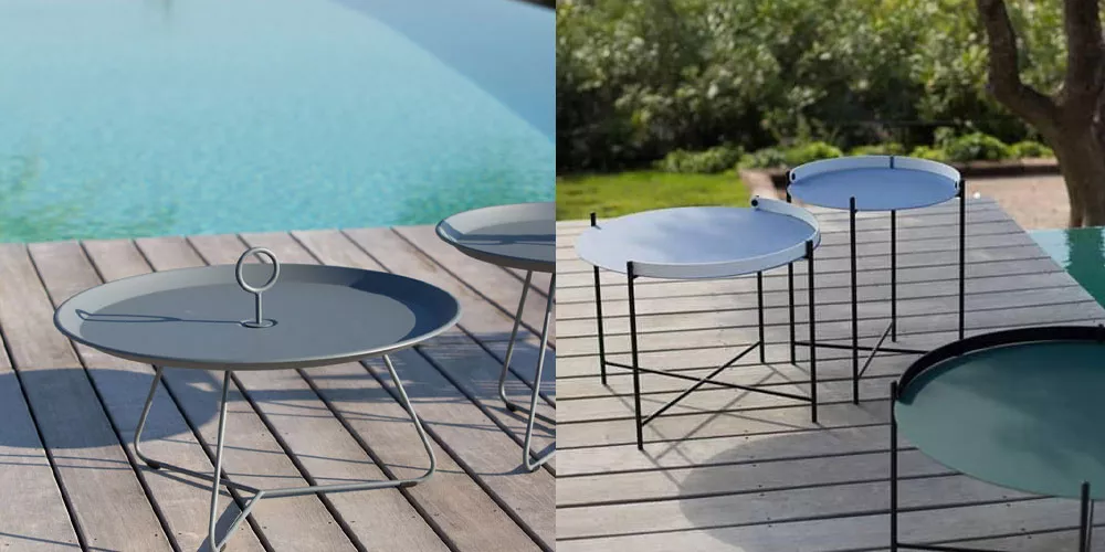 Grau-blauer Houe EYELET-Edge Tisch auf Holzterrasse am Pool, modernes Design, Outdoor-Möbel, entspannte Gartenatmosphäre.