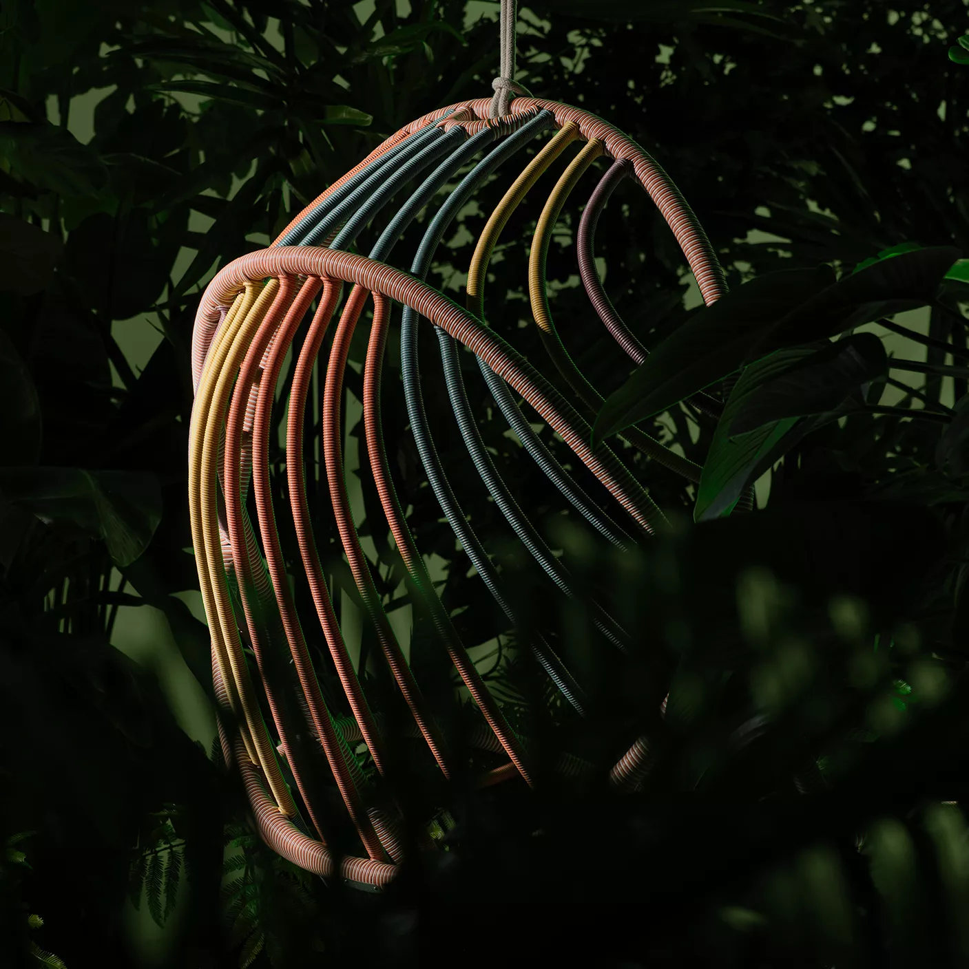Dedon Kida Hängesessel in bunten Farben hängt inmitten von üppigem grünem Laub und schafft eine entspannte und natürliche Atmosphäre
