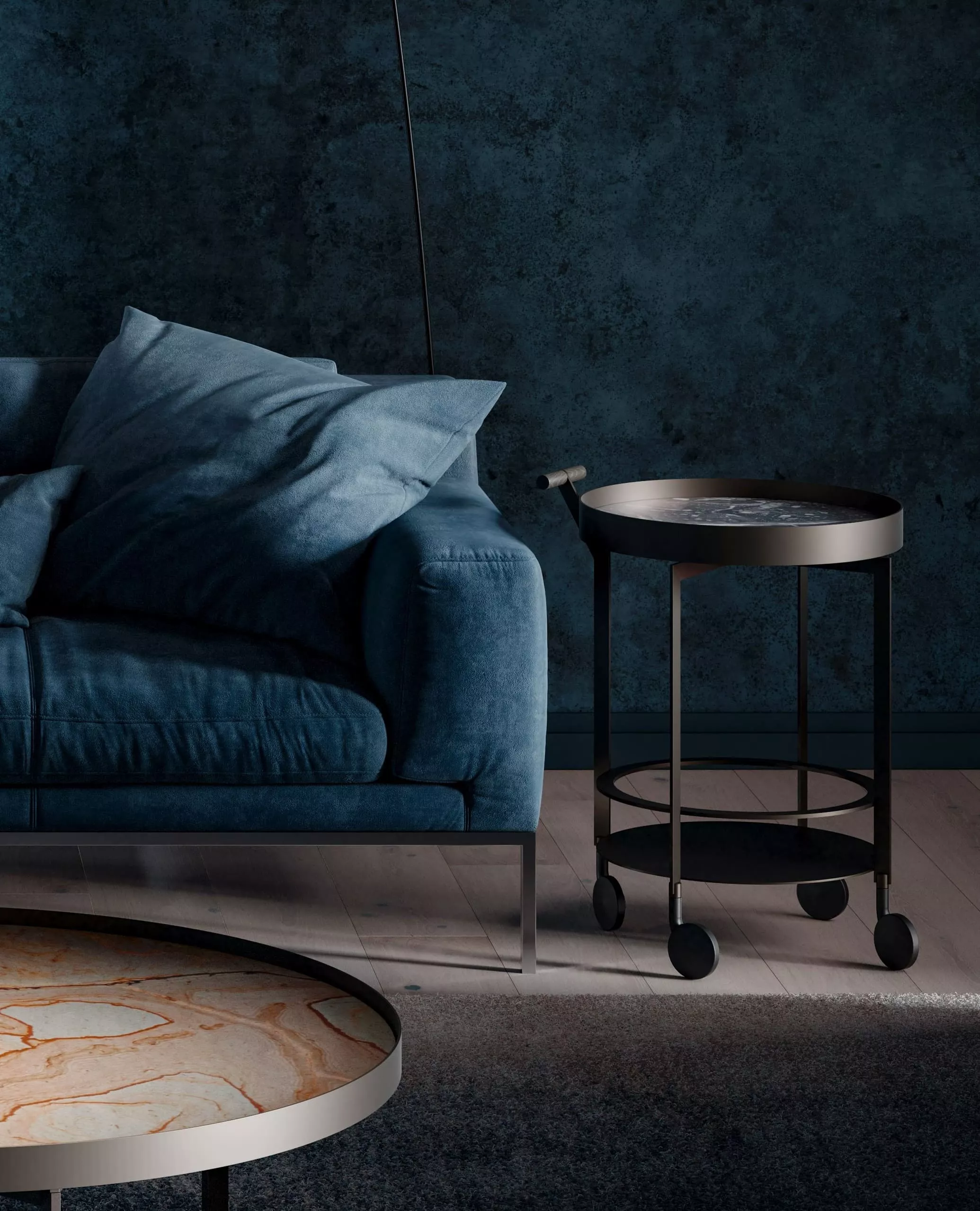 DRAENERT Day Couchtisch in einem Wohnzimmer mit einem blauen Sofa und einem runden Beistelltisch auf Rollen vor einer dunkelblauen Wand