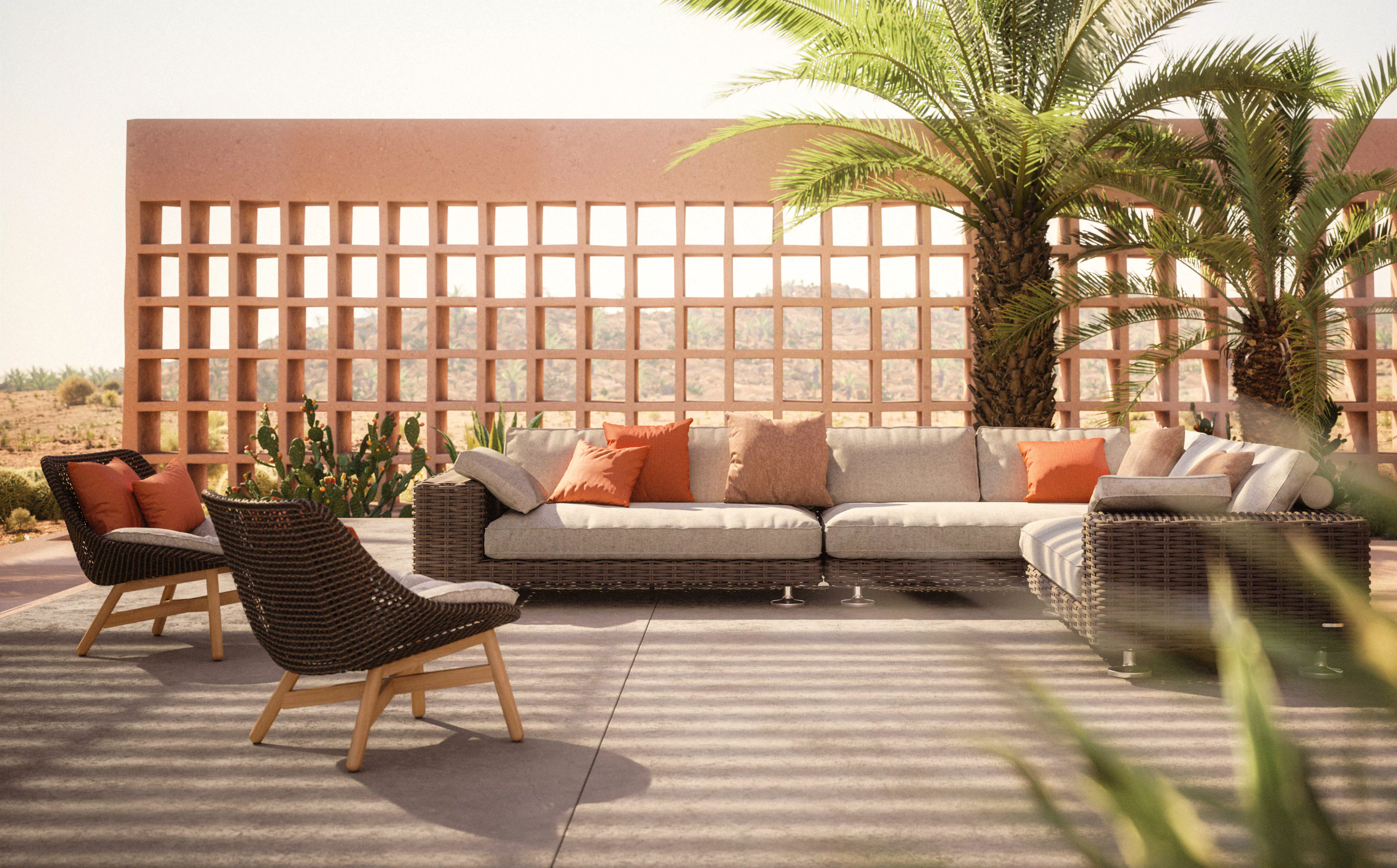 Dedon Mbrace Lounge-Möbel in einer Wüstenoase mit Palmen und Kaktus im Hintergrund