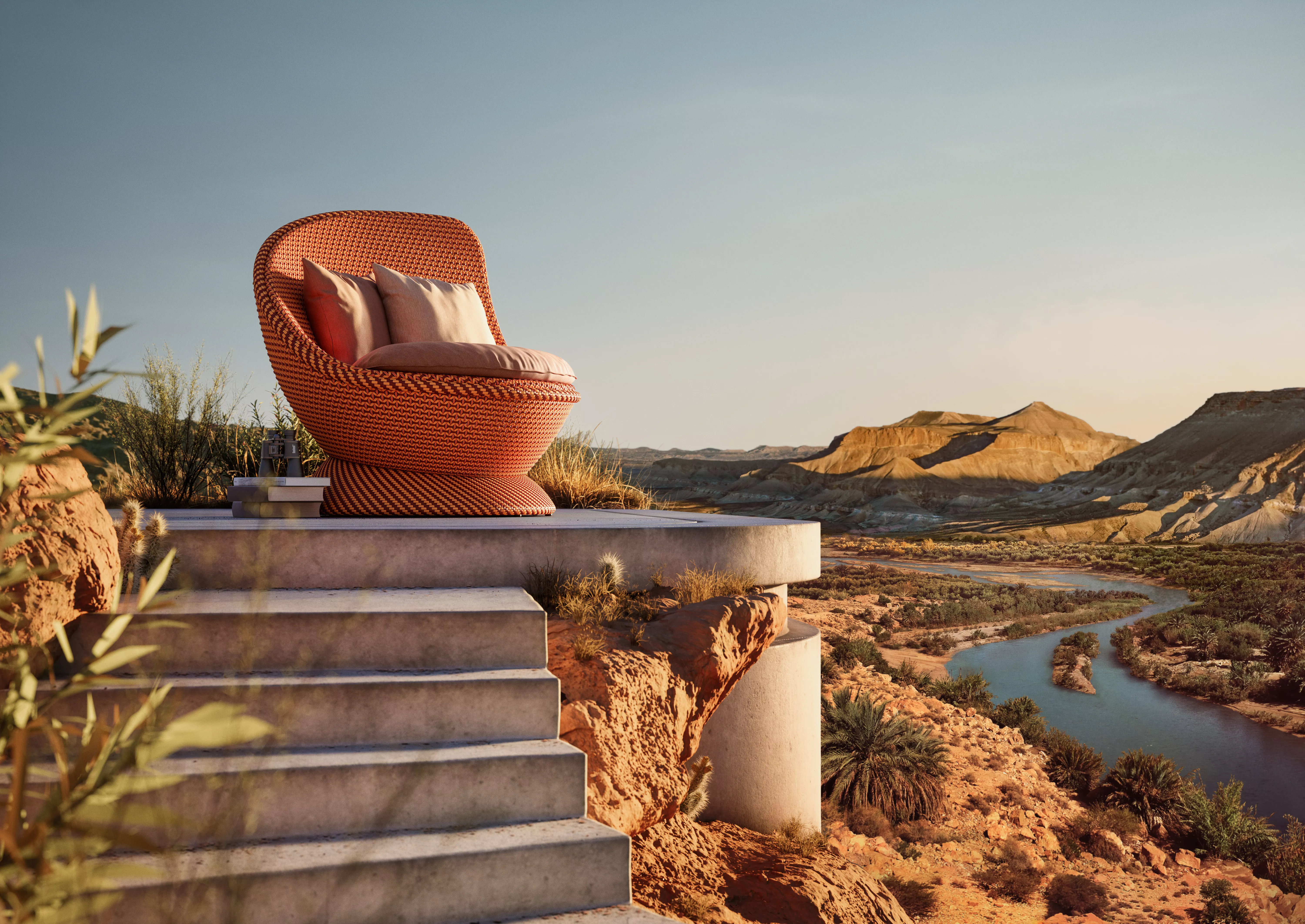 Ein Dedon Papyon Sessel in der Farbe Mysterious Desert steht auf einer Terrasse mit Blick auf eine malerische Wüstenlandschaft.