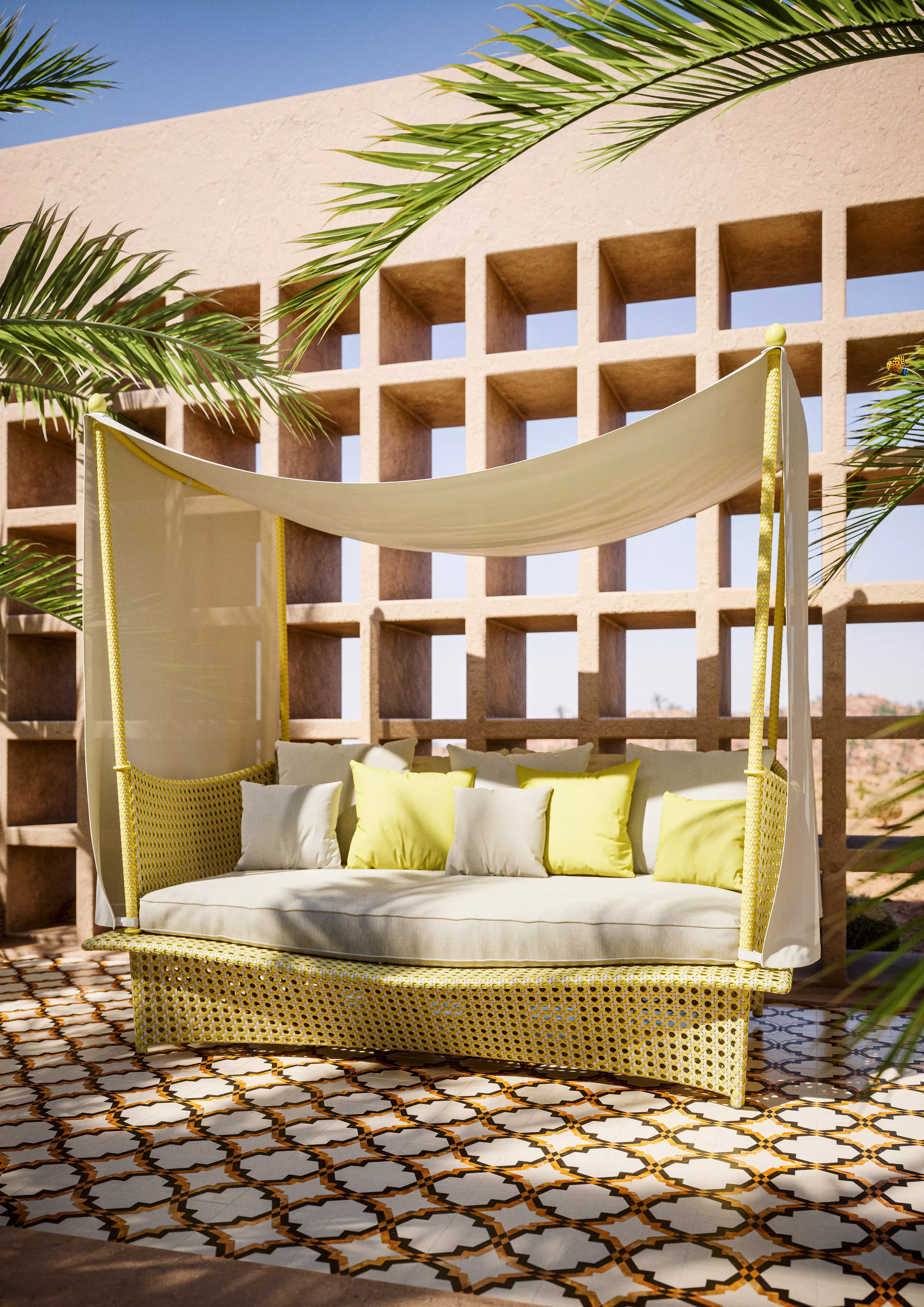 DEDON DAYDREAM Lounge-Sofa mit gelben Kissen steht auf einer gefliesten Terrasse umgeben von Palmen in einer sonnigen Umgebung