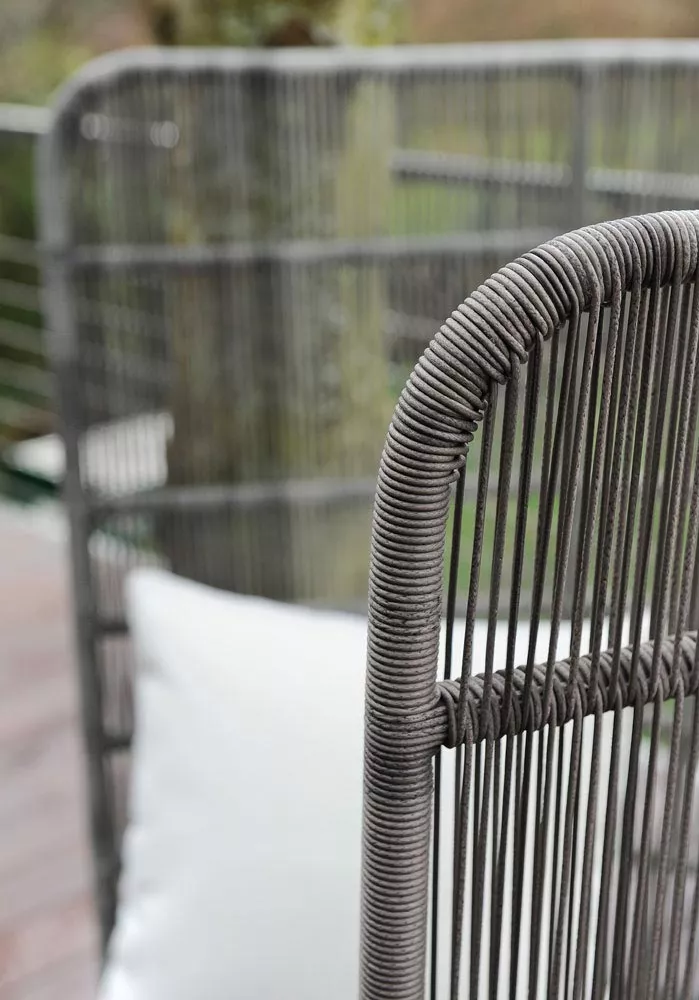 B&B Italia Canasta 13 Outdoor Gartenmöbel in Nahaufnahme mit Fokus auf die feinen Details der Flechtarbeit im Hintergrund unscharfe Naturumgebung