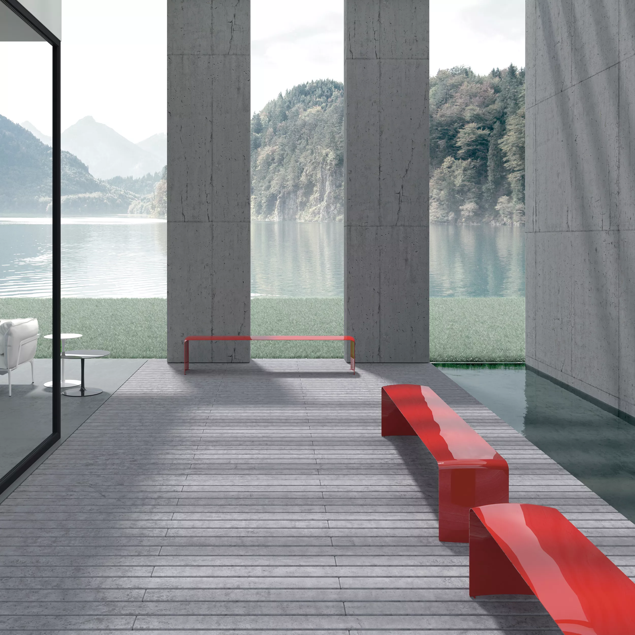 MDF Italia Le Banc Bank in rot steht auf einer Terrasse mit Blick auf einen See und Berge im Hintergrund