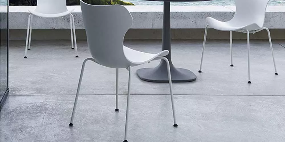 B&B Italia Papilio Stühle auf einer Terrasse mit Blick auf das Meer und einem runden Tisch in der Mitte