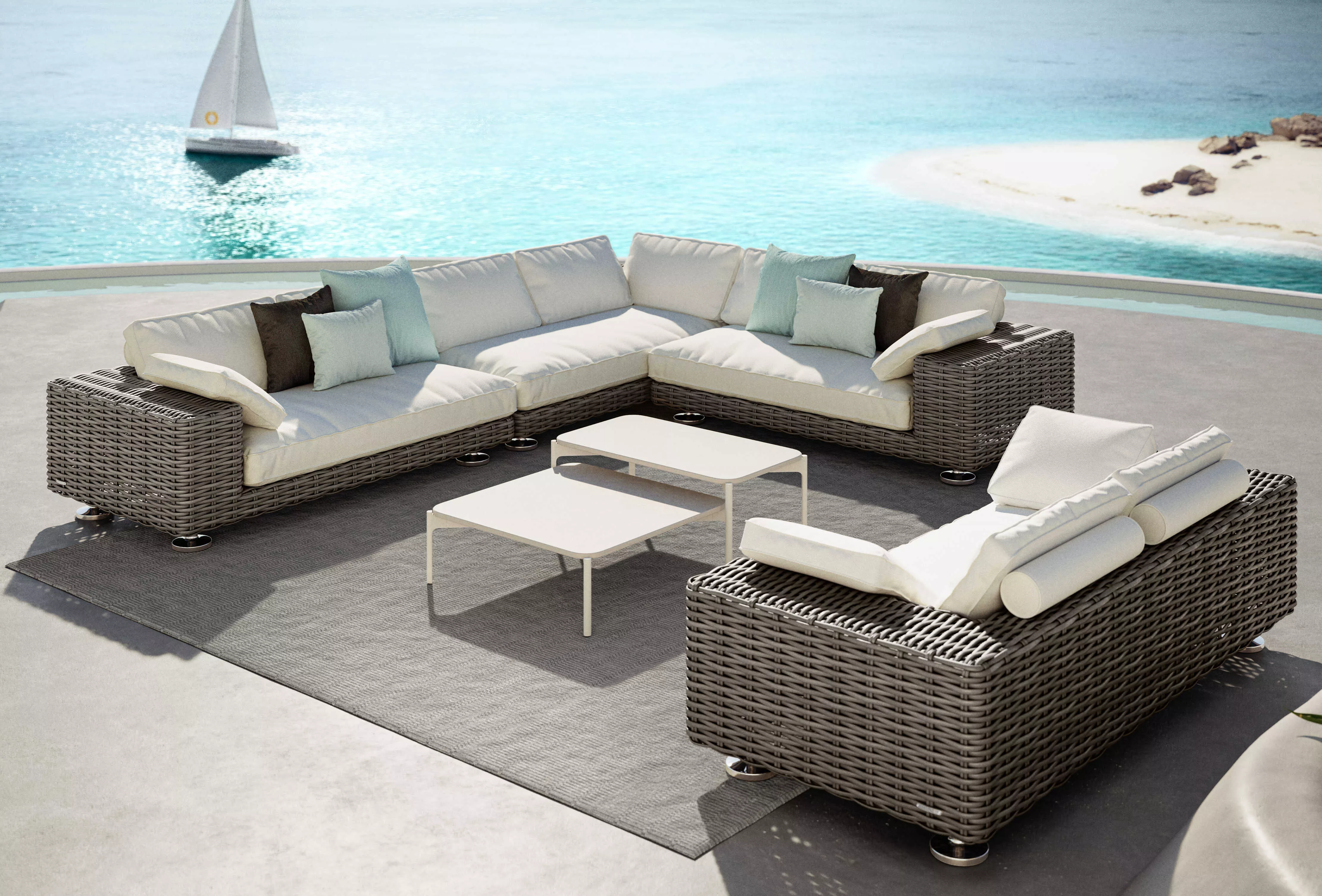 Dedon Endless Ocean Paros Izon Loungegruppe auf einer Terrasse mit Blick auf das Meer und ein Segelboot im Hintergrund