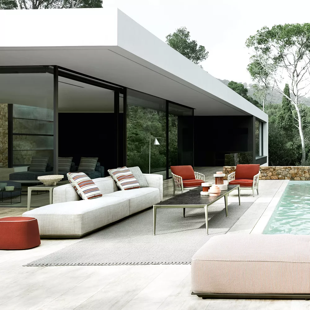 B&B Italia Hybrid Sofa in einer modernen Outdoor-Terrasse mit Pool und stilvollen Möbeln im Hintergrund.