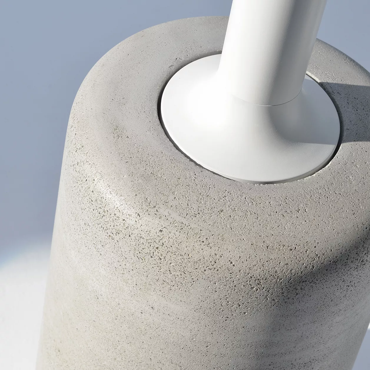 Nahaufnahme des MDF Italia Rock Table Tischs zeigt die Verbindung zwischen der weißen Tischsäule und der grauen Betonbasis ohne Hintergrund