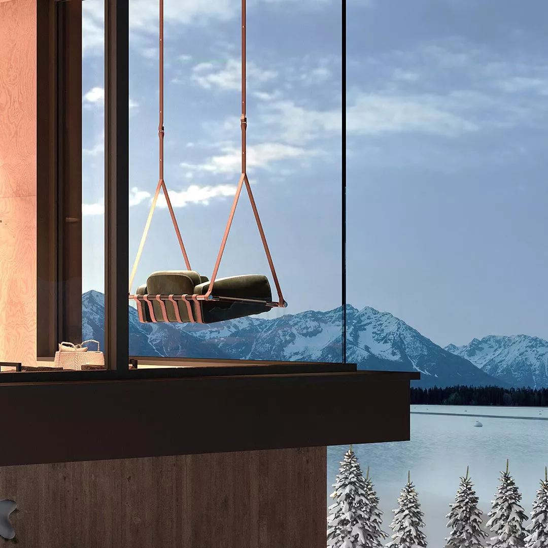 Schaukelsessel Fable von Myface in Rosa und Grün, hängend vor einer Glaswand mit Blick auf schneebedeckte Berge und See.