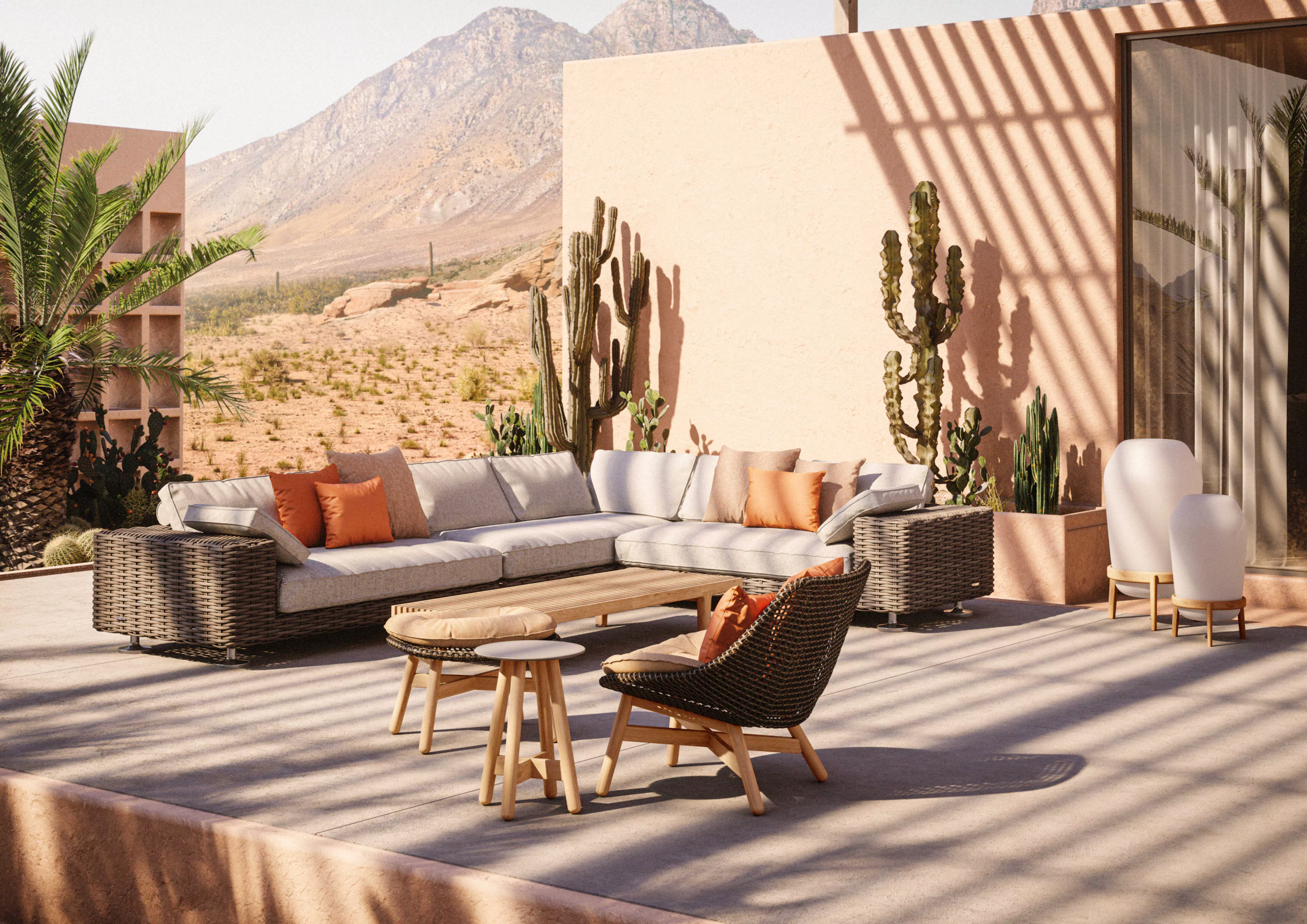 Dedon Mbrace Lounge Set in einer Wüstenoase mit bequemen Sitzgelegenheiten und Kaktuspflanzen im Hintergrund